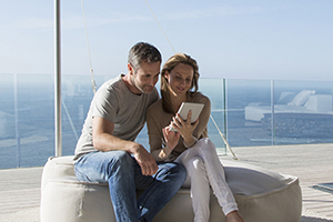 Jacksonville Audits with a wealthy couple on balcony